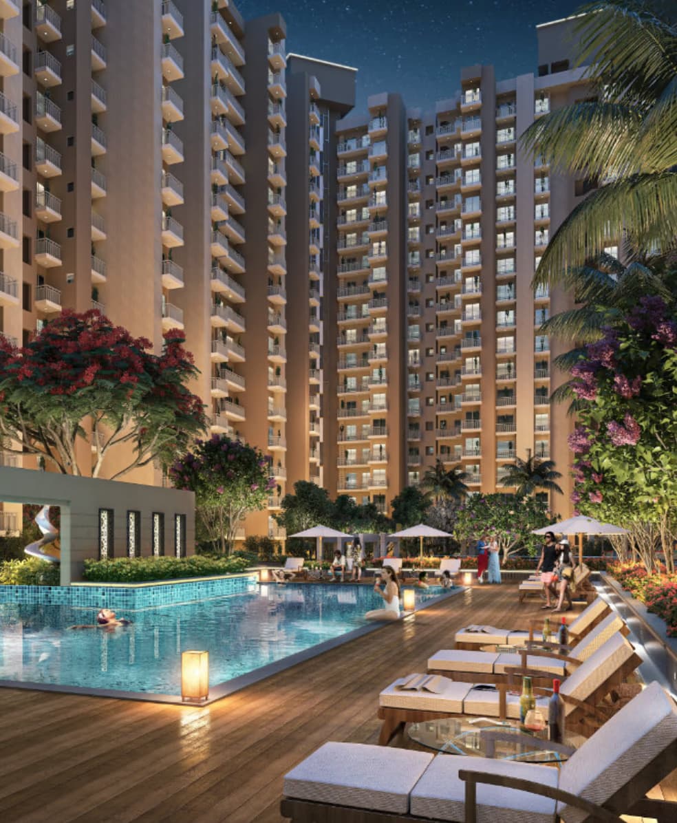 The swimming pool and timber sun deck at Mayfair Residency, lit in the evening
